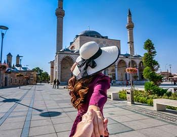women-tourists-holding-man-s-hand-leading-him-mosque-konya-turkey women-tourists-holding-man-s-hand-leading-him-mosque-konya-turkey