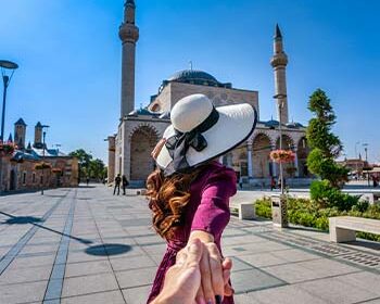 women-tourists-holding-man-s-hand-leading-him-mosque-konya-turkey women-tourists-holding-man-s-hand-leading-him-mosque-konya-turkey